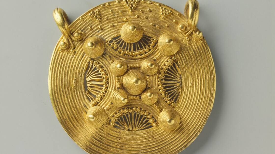 The large decorative gold disc.