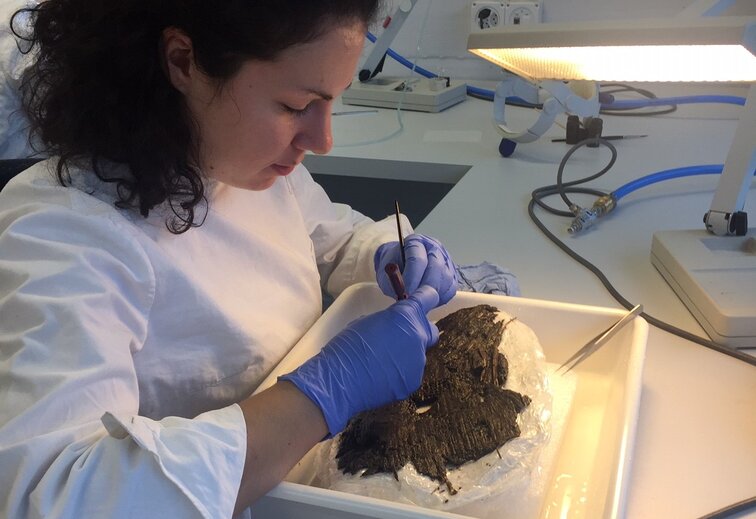 Conservator working on a fresh archaeological find